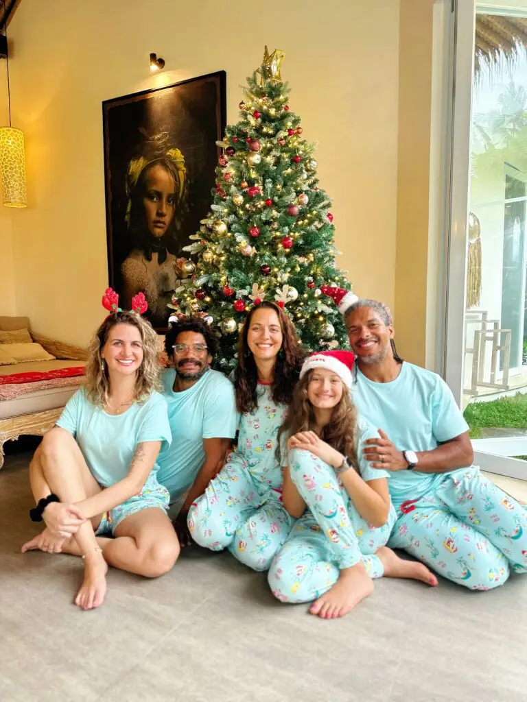 Family standing in front of Christmas tree at Kizmet Fit Retreats
